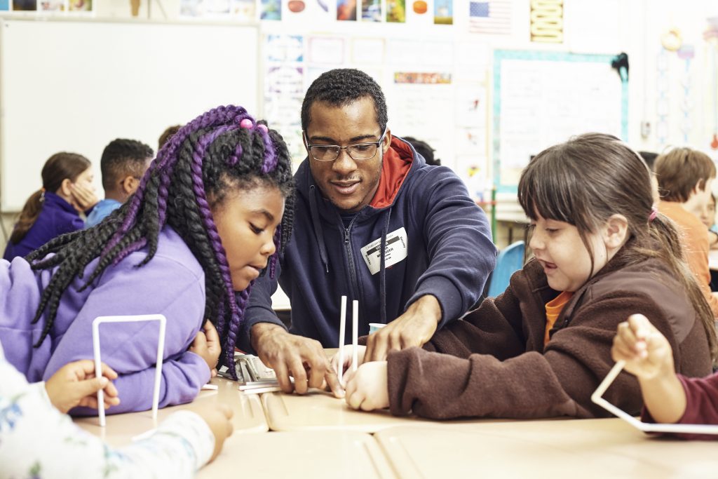 UT student teaches two Pond Gap Elementary students on Science Saturdays.